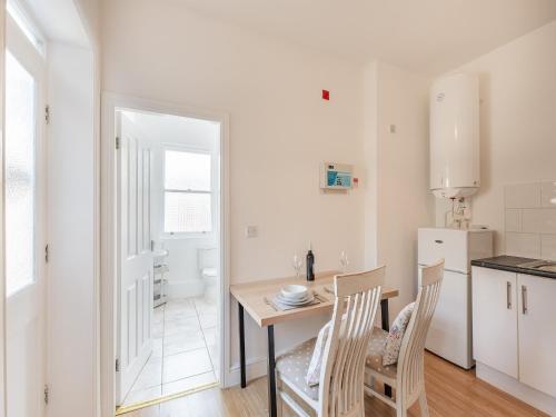 a kitchen and dining room with a table and chairs at Clifton Apartment - Uk42845 in Lytham St Annes