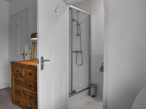 a bathroom with a shower with a glass door at High Bank Farm in Cockfield