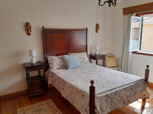 a bedroom with a large bed with two night stands at Casa Rural in Esposende