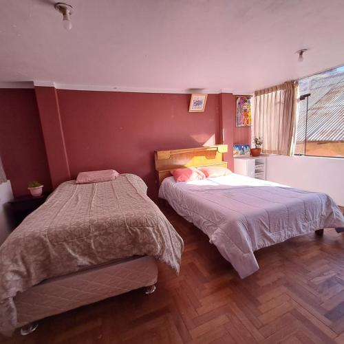 1 Schlafzimmer mit 2 Betten und einem Fenster in der Unterkunft Leonel in Puno