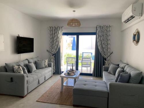 a living room with a couch and a table at Marassi in El Alamein