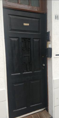 a black door with a sign on it at TECH Hostel in Sao Paulo