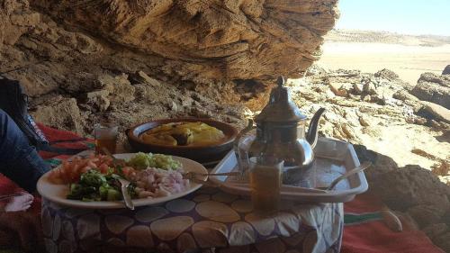 a table with a plate of food and a plate of food at sidi kaouki ayt karoum in Sidi Kaouki