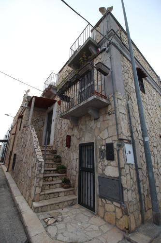 an old stone building with stairs and a balcony at Barone luxury rooms in Bari