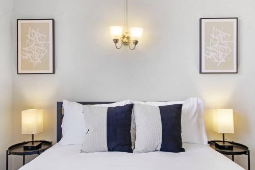 埃文斯頓的住宿－Inviting Evanston Studio Apartment - Elmgate Manor 403，卧室配有带两盏灯的白色床