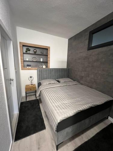a bedroom with a large bed in a room at Apartman Kis in Jajce
