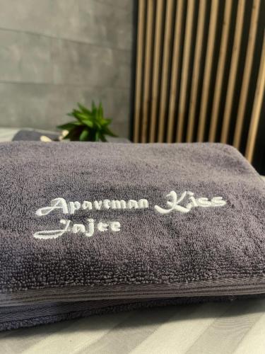 a blanket on a table with the name of a car at Apartman Kis in Jajce