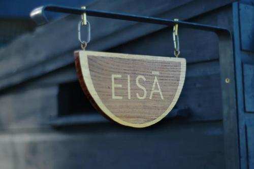 a wooden sign that says esa hanging on a building at Eisa Yurt in York