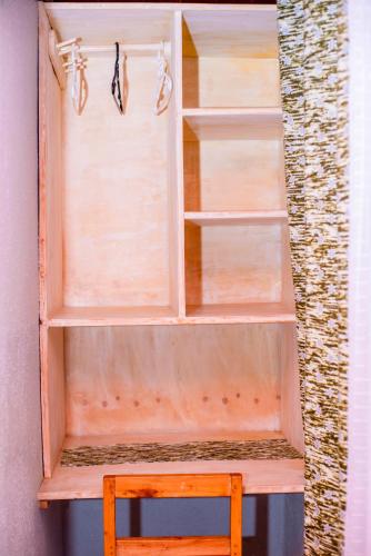 a wooden shelf with some pairs of glasses on it at Little Birds Paradise in Ruhengeri