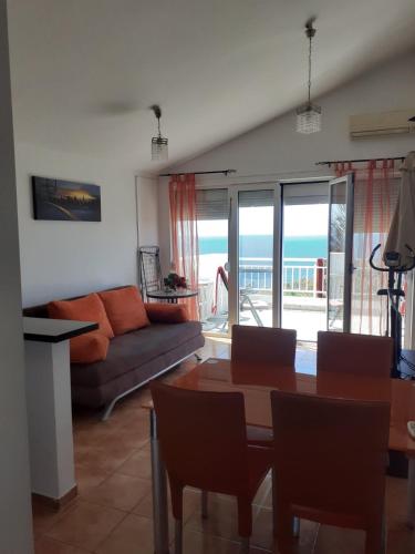 a living room with a couch and a table at Vila Natalia in Petrovac na Moru