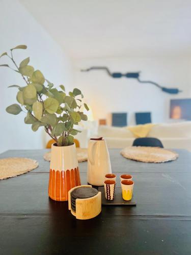 a table with three vases on it with a vase at Quinta do Evaristo in Évora