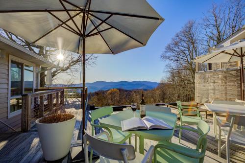 a patio with a table and chairs and an umbrella at Fire Mountain in Highlands