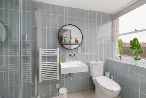 ein Badezimmer mit einem WC, einem Waschbecken und einem Spiegel in der Unterkunft Bath Abbey View - City Centre in Bath