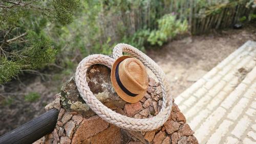 a cowboy hat sitting on top of a wall at Sardinian Seaside Retreats in Badesi