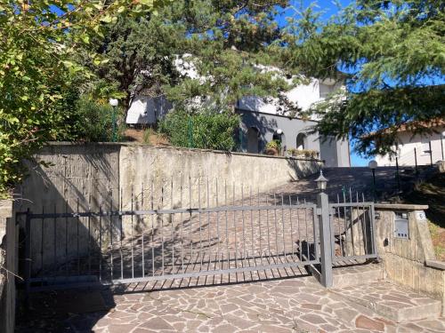 a gate in front of a stone wall with trees at Attico Marsiglie in Casal Fiumanese