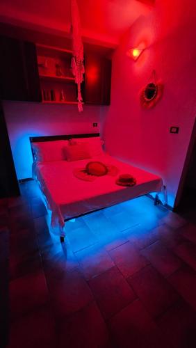 a red room with a bed with a red light at Sardinian Seaside Retreats in Badesi