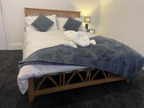 a bedroom with a bed with two towels on it at Ashfield New Place in Newcastle under Lyme