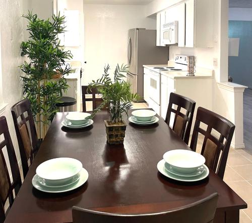 a dining room table with four chairs and a kitchen at Private room Plano in Plano