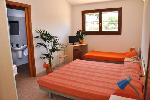 a bedroom with a bed and a sink at La Corte Degli Ulivi in Cardedu
