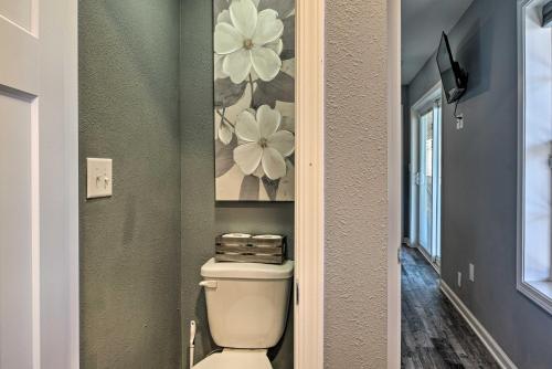 a bathroom with a toilet and a painting on the wall at Pet-Friendly Branson Area Home Hot Tub, Game Room in Reeds Spring