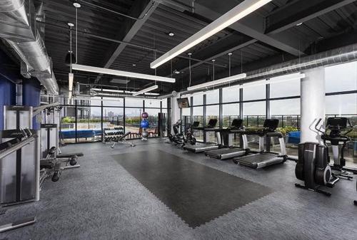 a gym with a bunch of treadmills and machines at Sleek downtown Cleveland apartment in Cleveland