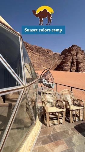 a group of wicker chairs sitting on top of the desert at Sunset colors camp in Wadi Rum
