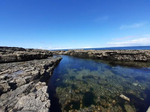 a body of water with rocks in the water at Shannon Park House in Sligo