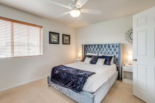 a bedroom with a bed and a ceiling fan at Inviting Denver Home with Yard about 6 Mi to Airport! in Aurora