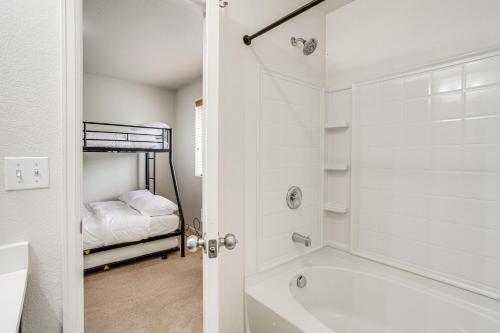 a bathroom with a bath tub and a bed at Inviting Denver Home with Yard about 6 Mi to Airport! in Aurora
