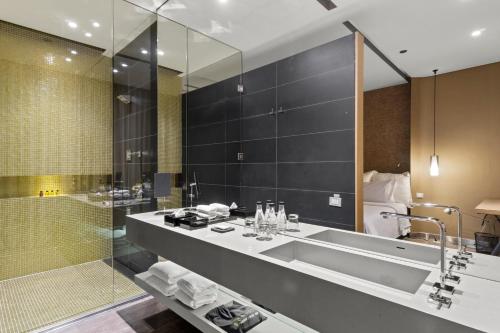 a bathroom with a tub and a sink and a shower at BOG Hotel in Bogotá