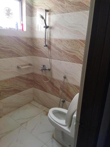 a bathroom with a toilet and a shower at Tranquil apartments in Islamabad