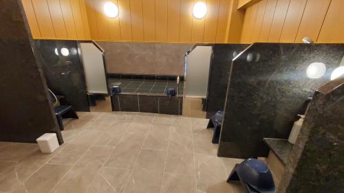 a bathroom with two toilets and ailed floor at Tourist Inn Kochi in Kochi