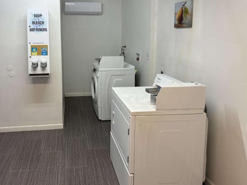 a laundry room with two washer and dryers in it at Motel 6 Englewood, FL in Englewood