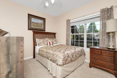 a bedroom with a bed and a window and a dresser at 1049 Branson Luxury retreat-Golf view-Silver Dollar city in Branson West