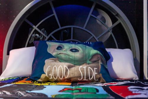 a baby yoda pillow sitting on top of a bed at Thematic House with Private pool and Game Room in Loughman
