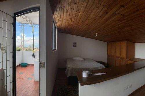 a small room with a bed and a bathroom at Cómodo dúplex. Vista a la ciudad in Cali