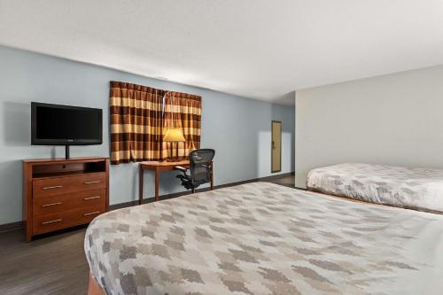 a hotel room with two beds and a flat screen tv at Americas Best Value Inn Carlisle in Carlisle