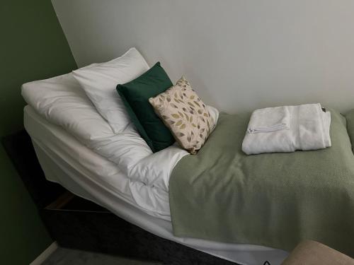 a white couch with four pillows on it at Leicester Oadby 4 bed home, 8 guests, park 5 cars in Oadby