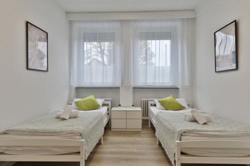 Postel nebo postele na pokoji v ubytování Moderne Ferienwohnungen - Service wie im Hotel