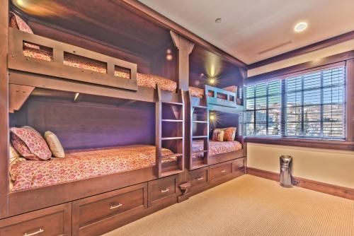 two bunk beds in a room with a window at Year Round Recreation Luxury Resort Amenities and Hot Tub Access! Deer Valley Arrowleaf 211 in Park City