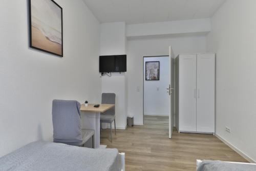 TV a/nebo společenská místnost v ubytování Moderne Ferienwohnungen - Service wie im Hotel