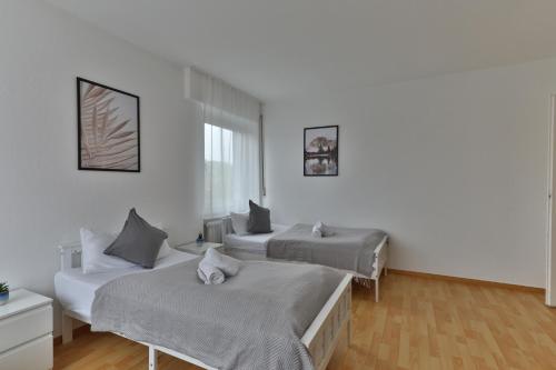 Postel nebo postele na pokoji v ubytování Moderne Ferienwohnungen - Service wie im Hotel