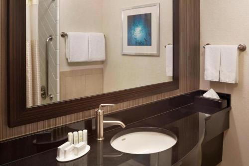 a bathroom with a sink and a mirror at Courtyard by Marriott Fishermans Wharf in San Francisco