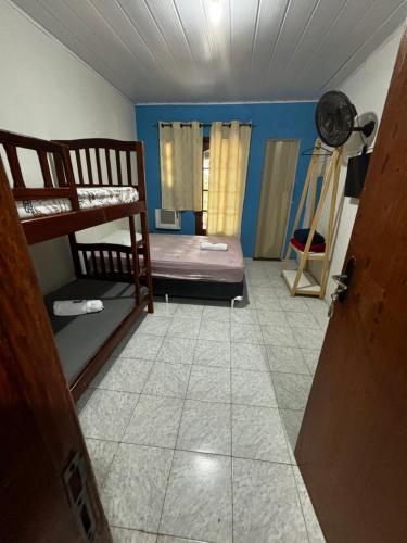a room with two bunk beds and a tile floor at SUITES Recanto do DO Mar in Saquarema