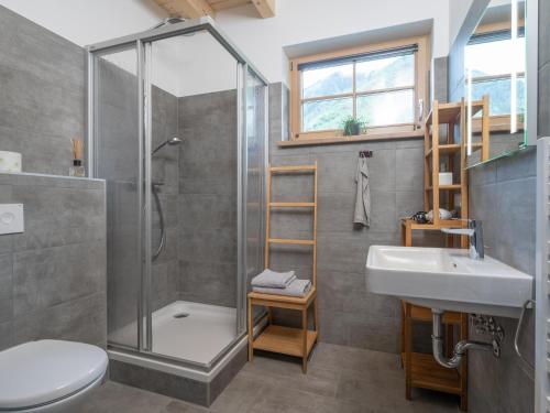 a bathroom with a shower and a toilet and a sink at Haus Elau in Donnersbachwald