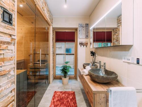 a bathroom with two sinks on a wooden counter at Chalet Thor in Donnersbachwald