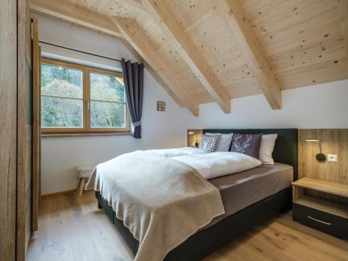 a bedroom with a bed and a large window at Haus Laura in Donnersbachwald