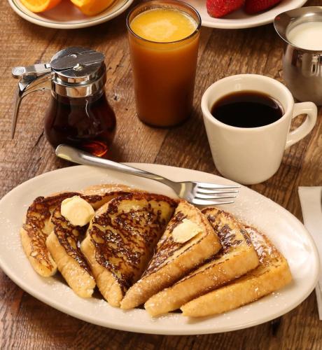 a plate of french toast with peanut butter and bananas at Fitzroy Hall in Charlottetown