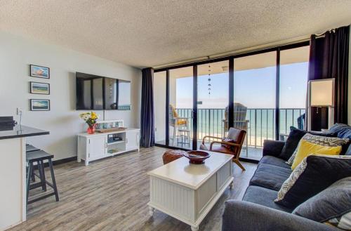 a living room with a couch and a table at 0510 Beachtrippin' home in Carolina Beach
