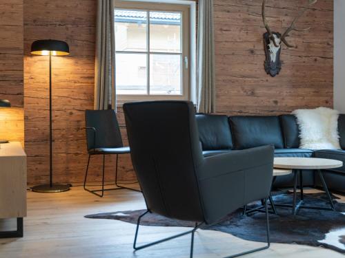 a living room with a couch and a table at Villa Petra in Donnersbachwald